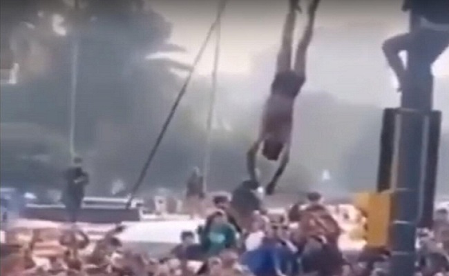 العراقيون يعدمون مسلحا ويعلقون جثته على عمود ببغداد بعد قتله 4 متظاهرين